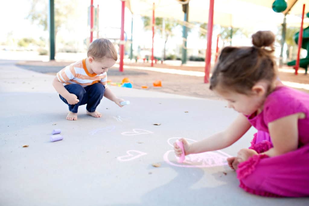 Kids playing with chalk at the playground