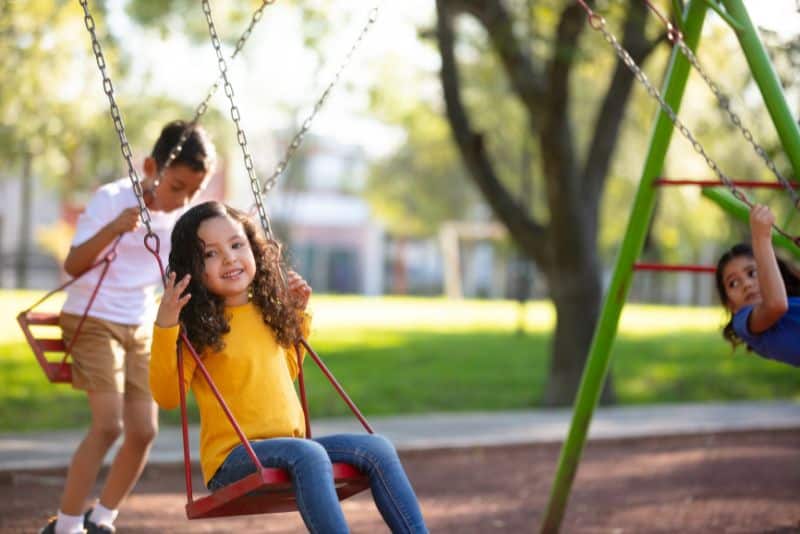 Playground Equipment Names (With Pictures) 8 Girl swinging on swing