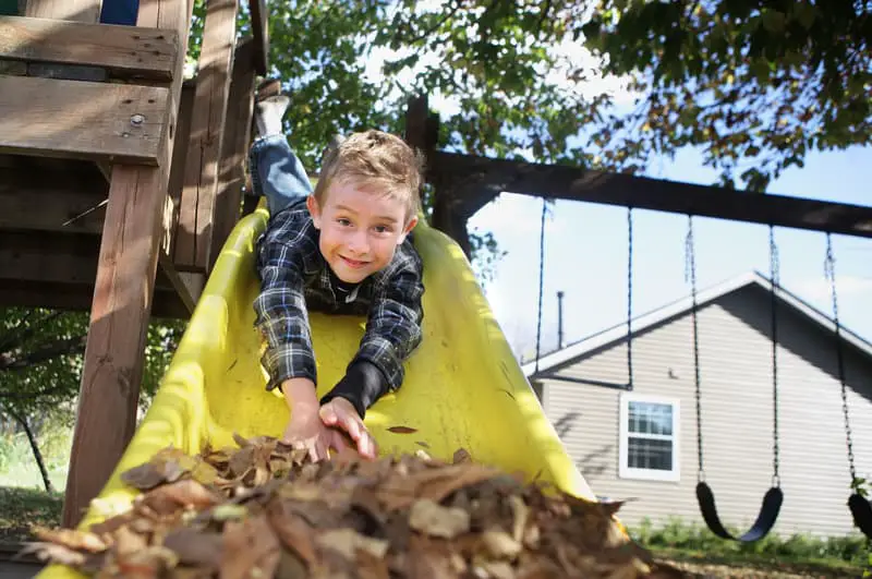 Canva Happy Boy Sliding Head First down a Slide