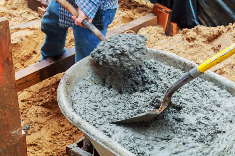 Canva Worker pouring concrete to formwork construction site