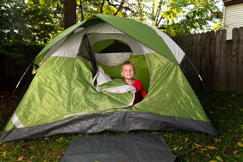 Canva 1 Little Boy Plays Alone in His Backyard Inside of a Green Camping Tent